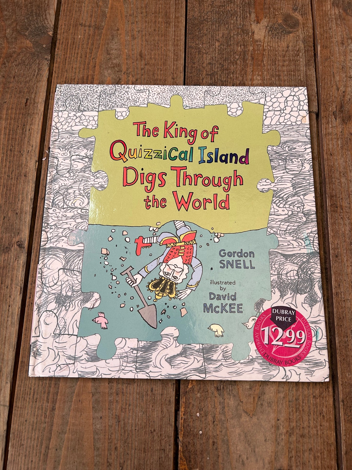 The king of quizzical island digs through the world