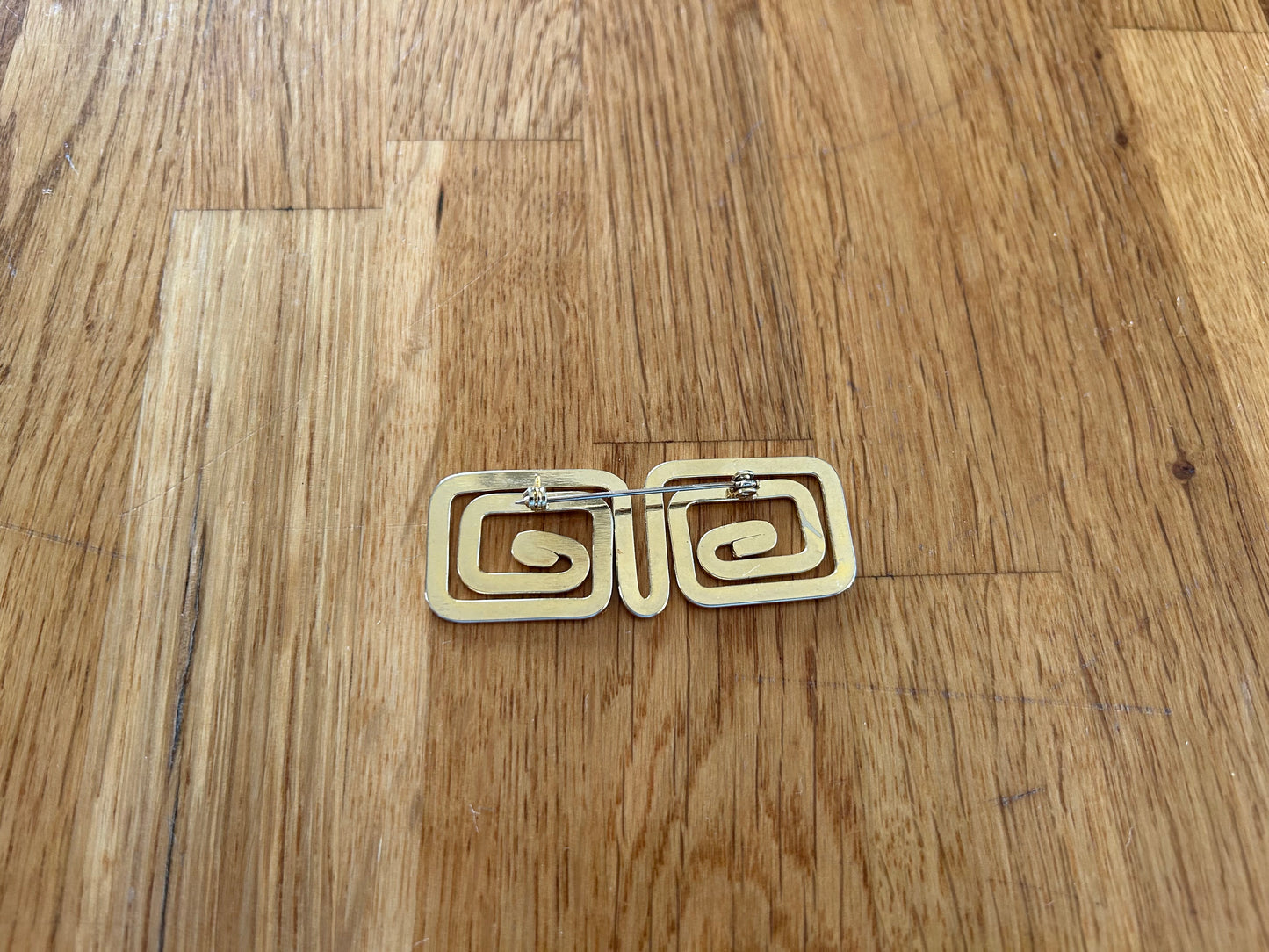 Golden geometric brooch