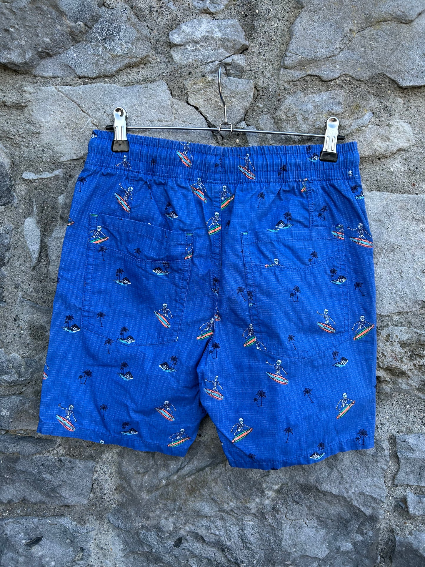 Surfing skeletons blue shorts 12y (152cm)