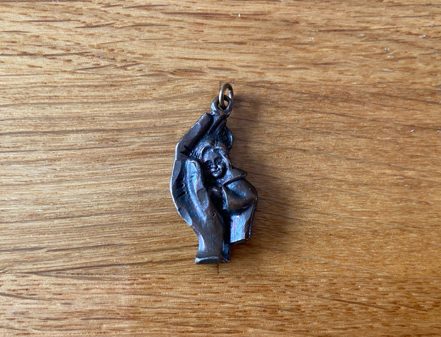 Baby in hand pendant