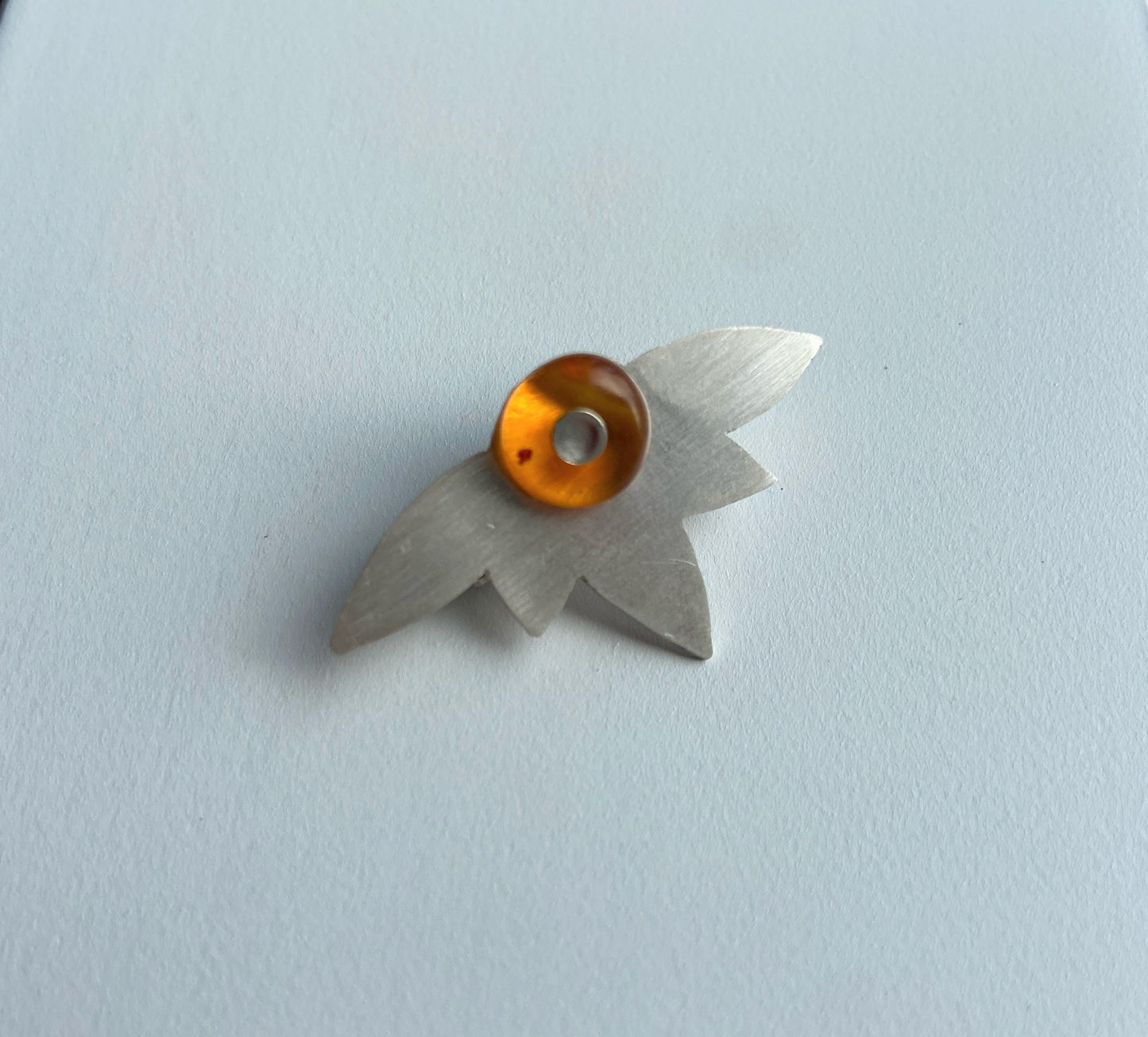 Amber and silver brooch